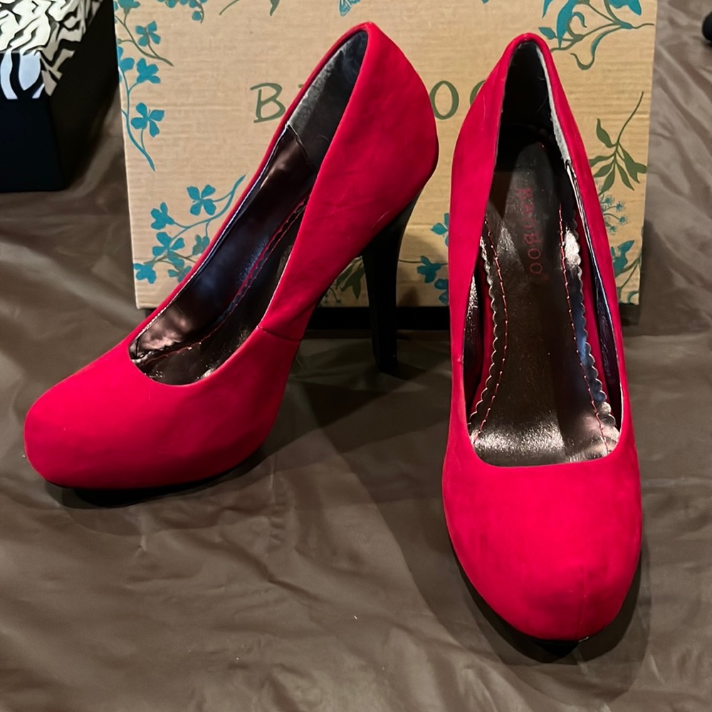 New in box size 7 red suede stiletto with a black heel